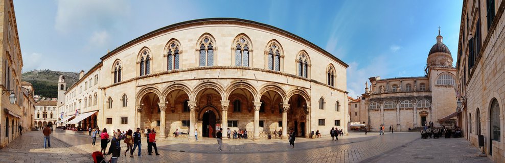 Tourists visit Sponza Palace in Luža Square, Dubrovnik Old Town, Croatia on spring afternoon