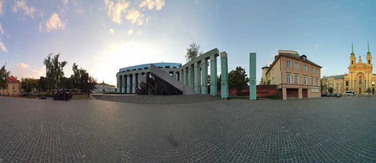 Warsaw Uprising Monument and St. Martin's Church at sunset in Warsaw, Poland
