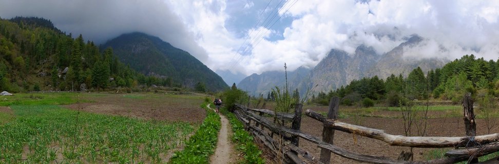 Hikers on mountain trail through agricultural valley between Bagarchhap and Chame, Annapurna Conservation Area, Nepal