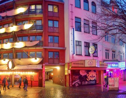 Hamburg St. Pauli nightlife district with Heiermann Club and Hamburger Veermaster at blue hour