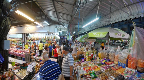 Evening street market food vendors with tourists shopping in Hat Yai, Thailand