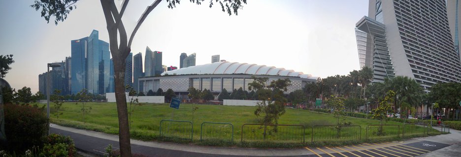 Singapore Marina Bay skyline with Singapore Indoor Stadium and Marina Bay Sands at dusk