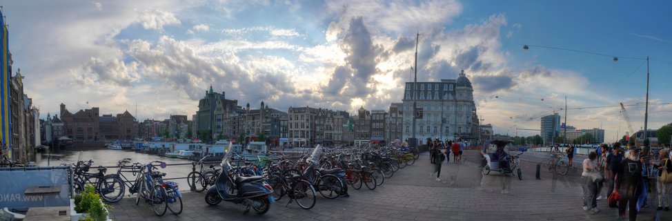 Amsterdam Canal Waterfront with Historic Dutch Architecture and Bicycles at Sunset