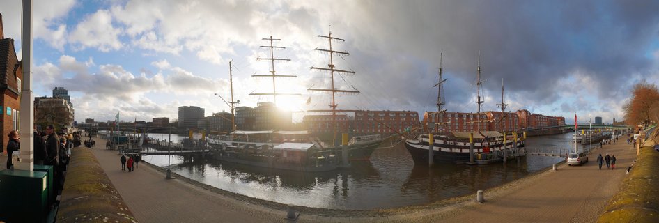 Historic tall ships moored at Schlachte Embankment on Weser River in Bremen, Germany