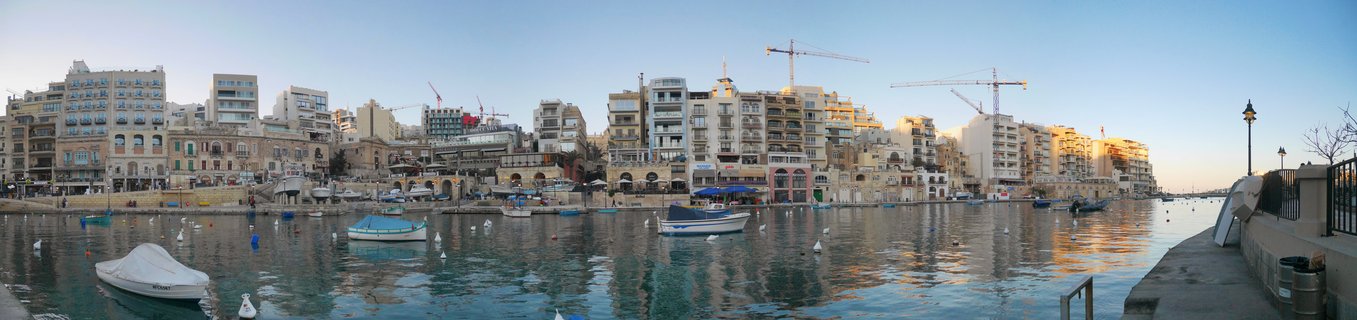 Sliema waterfront harbor with boats and Mediterranean architecture at golden hour, Malta