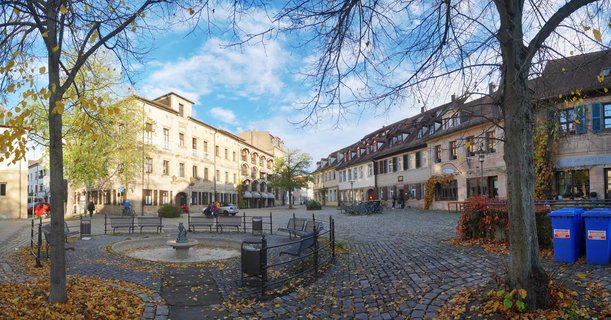 Historic town square with fountain and traditional Franconian architecture in Erlangen, Germany during autumn